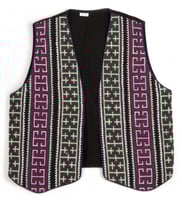 Color image of a reversible cotton vest with front panels of geometric cross-stitching made by a Minnesotan Hmong woman and sold by the Southeast Asian Ministry. Worn by Bea Vue-Benson, c.1999.